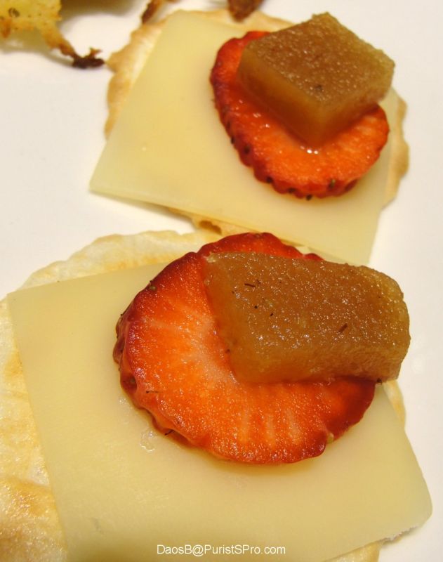 Crackers with cheese and fruit.