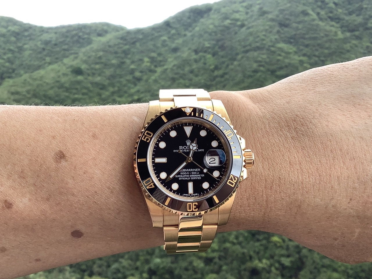 gold submariner on wrist