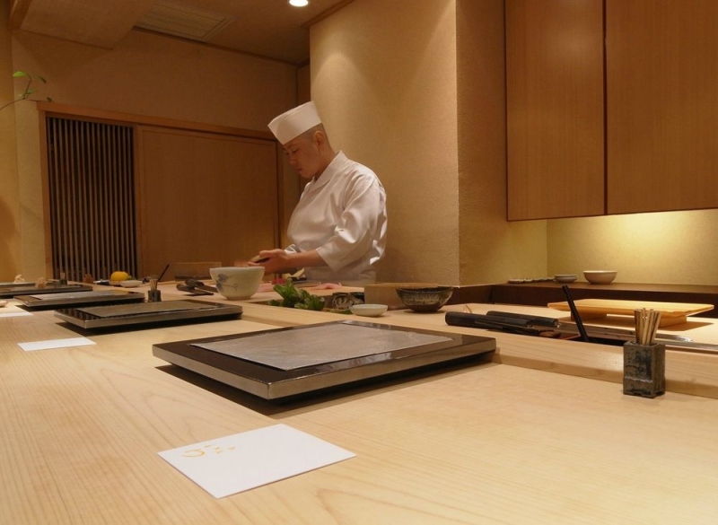 You'd find a sushi counter for 6. That's Iwa san preparing for the course.