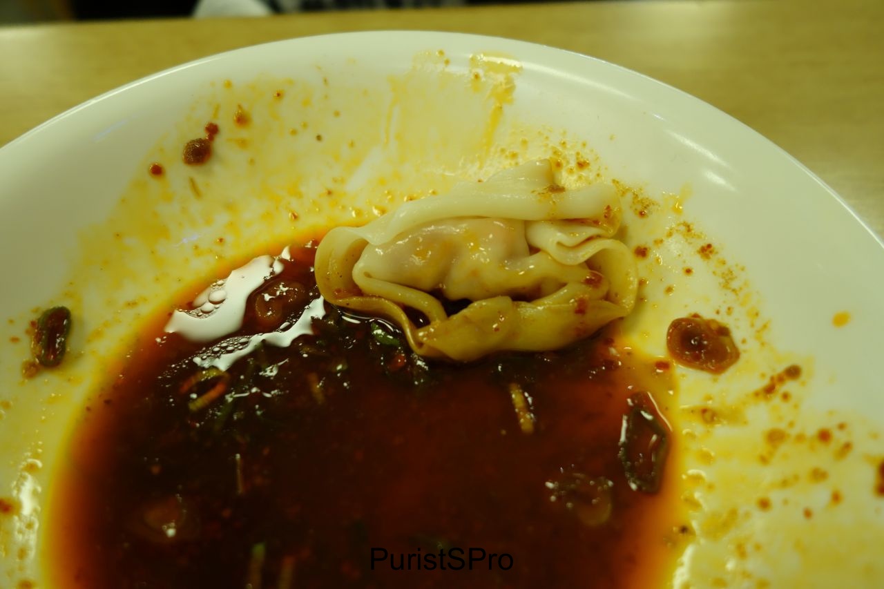 A shrimp dumpling in spicy red chili sauce. Decadent shrimp, a skin that was perfect, and a chili sauce that was fragrantly spicy but not overly spicy. . 