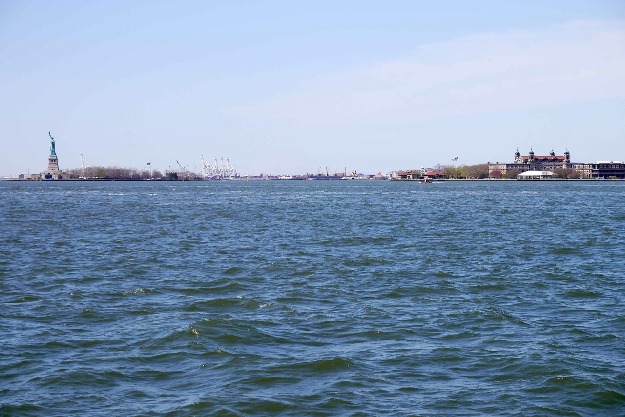 Statue of Liberty on left and Ellis Island on the right