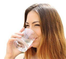 Image of a woman drinking water from a glass.