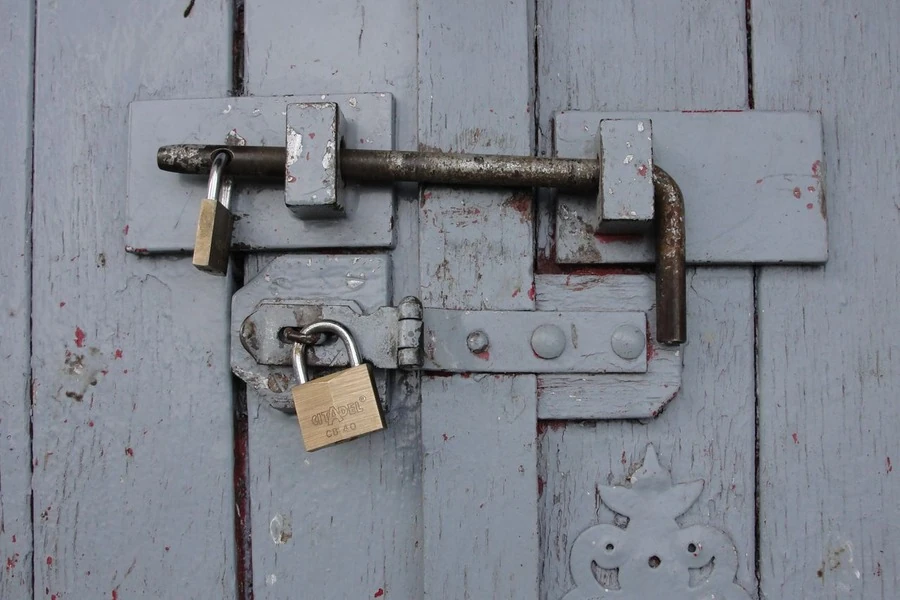 A padlock on a wooden door