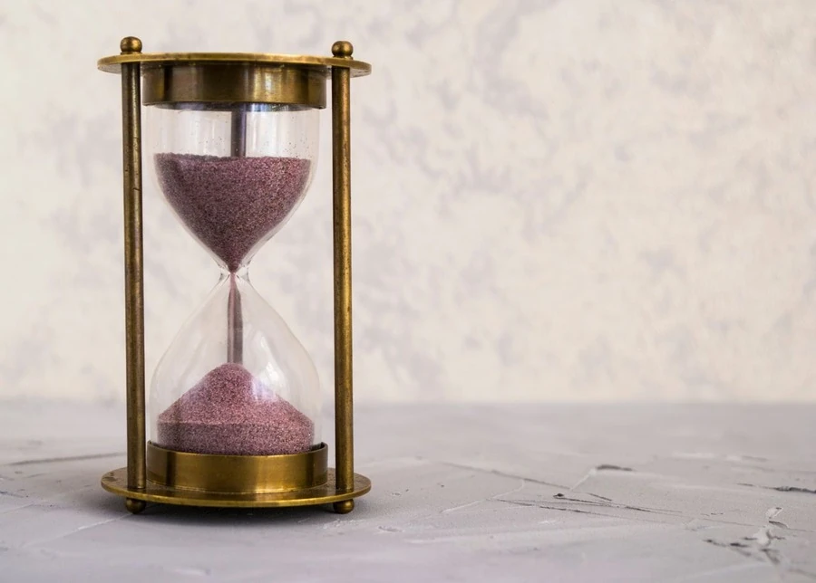 An hourglass with sand running through