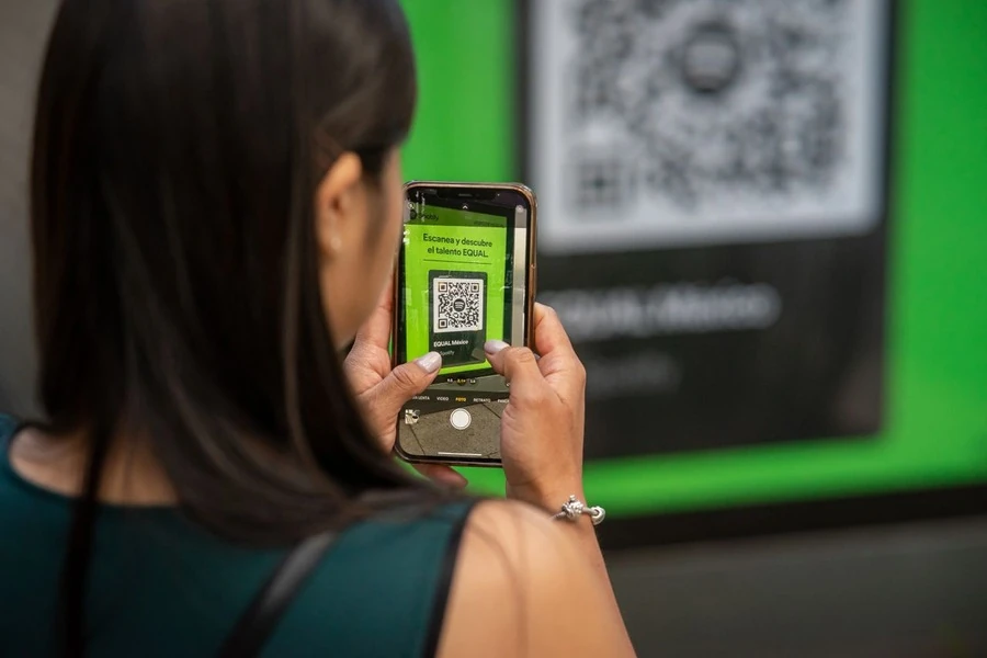 A woman scanning a QR code with her phone