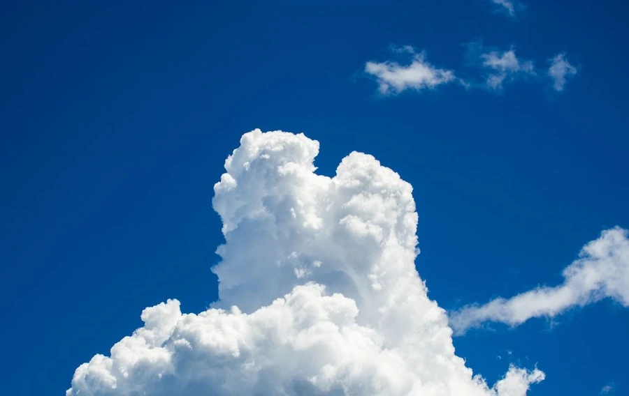 Bright white clouds against a deep blue sky