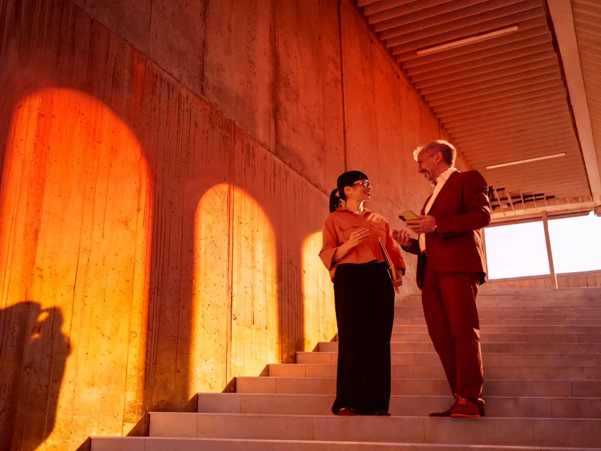 Two advisors chatting on a staircase