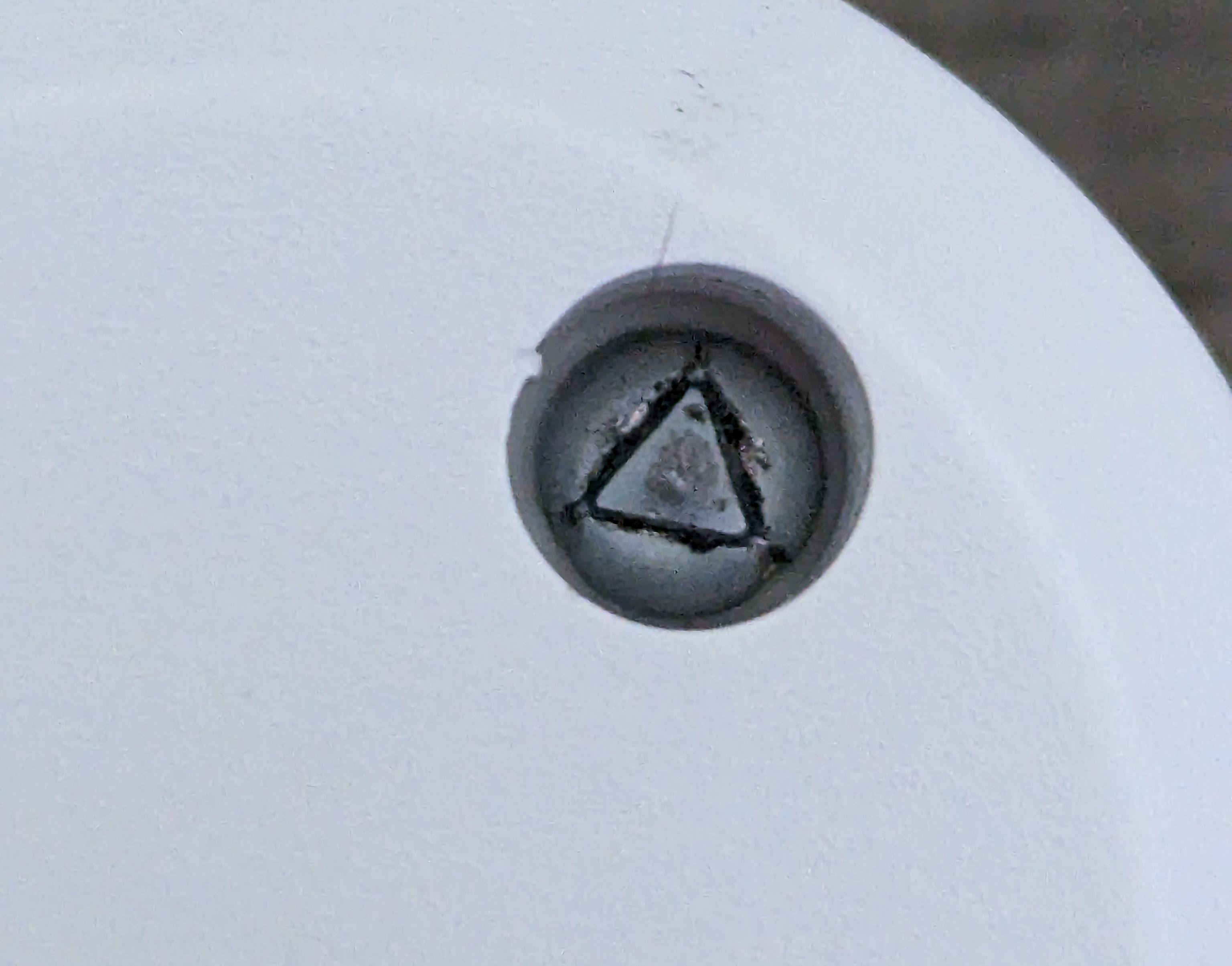 Philips smart outlet close-up of triangle screw