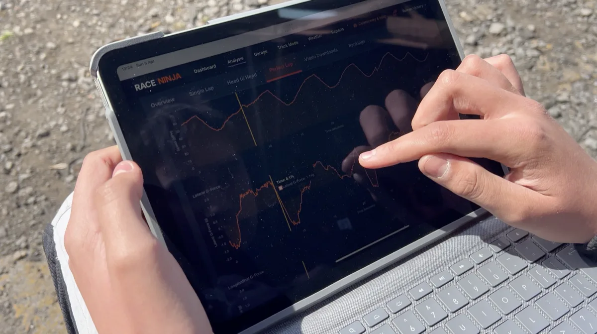 Reviewing Race Ninja telemetry data on a tablet trackside between sessions