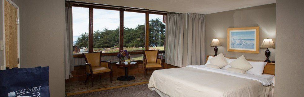 bed with windows overlooking grassy area