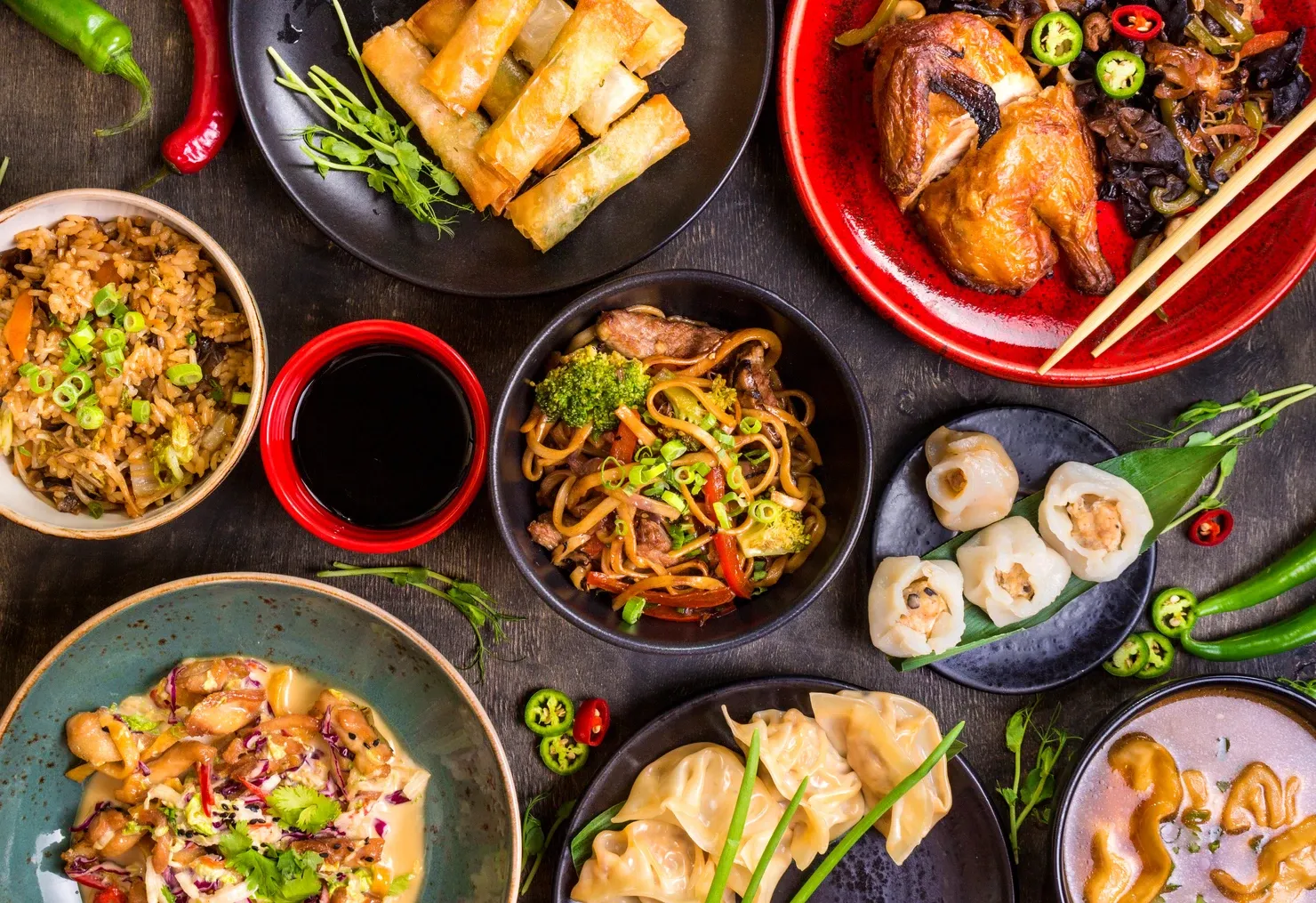 Assorted Chinese food set. Chinese noodles, fried rice, dumplings, peking duck, dim sum, spring rolls. Famous Chinese cuisine dishes on table.