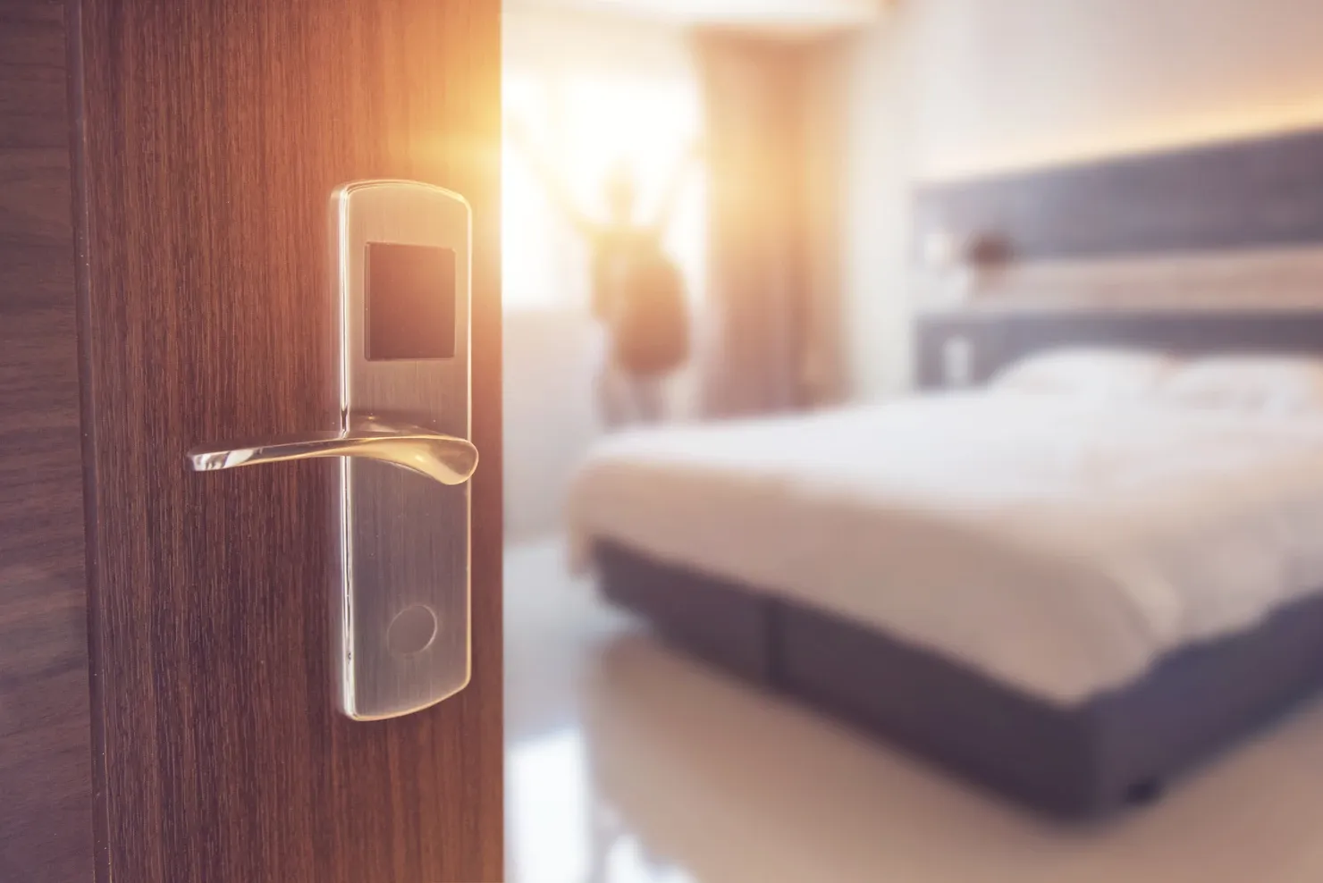 Opened door of hotel room in the morning 
