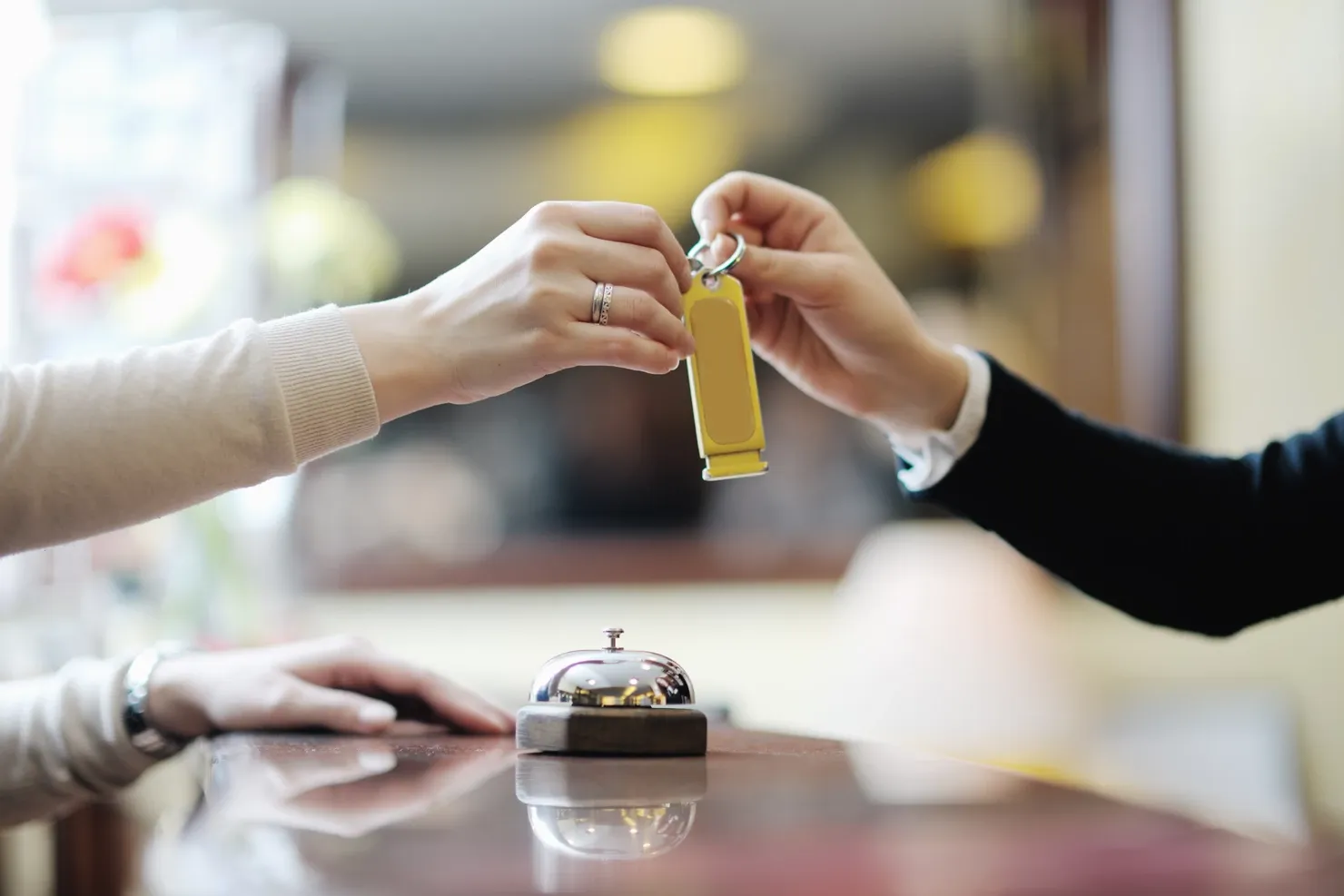 A woman at the reception of a hotel checking in
