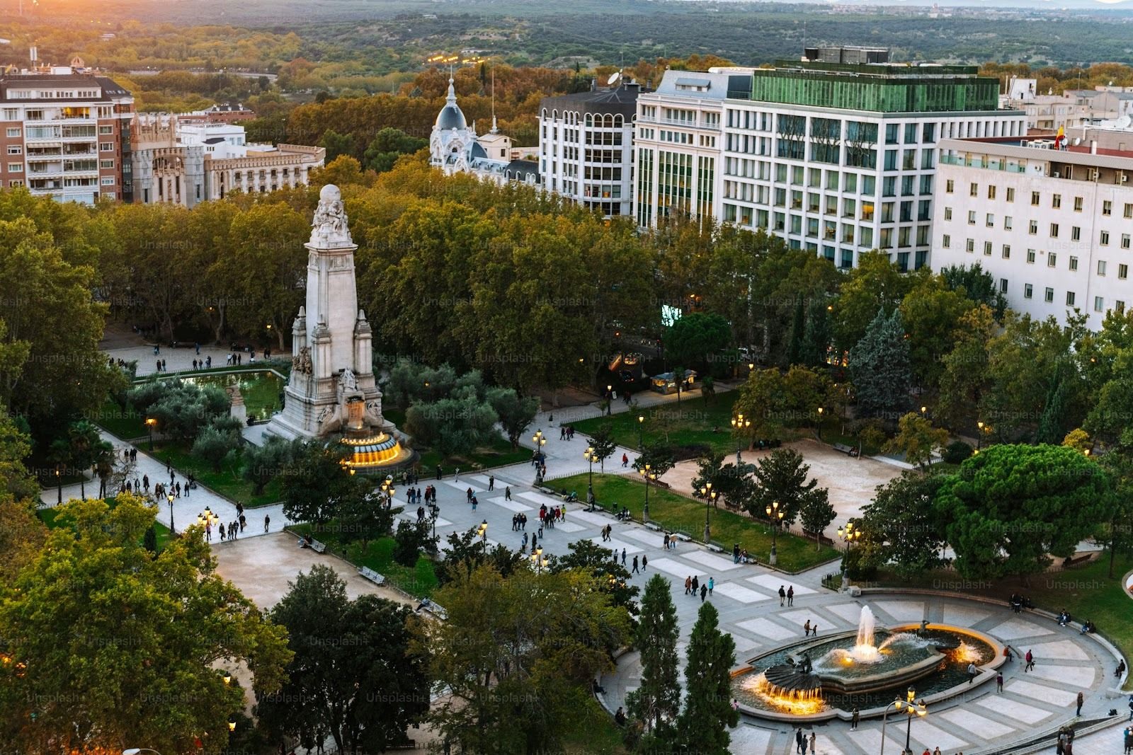 Aerial view of Madrid's crowded Plaza España square at dusk.