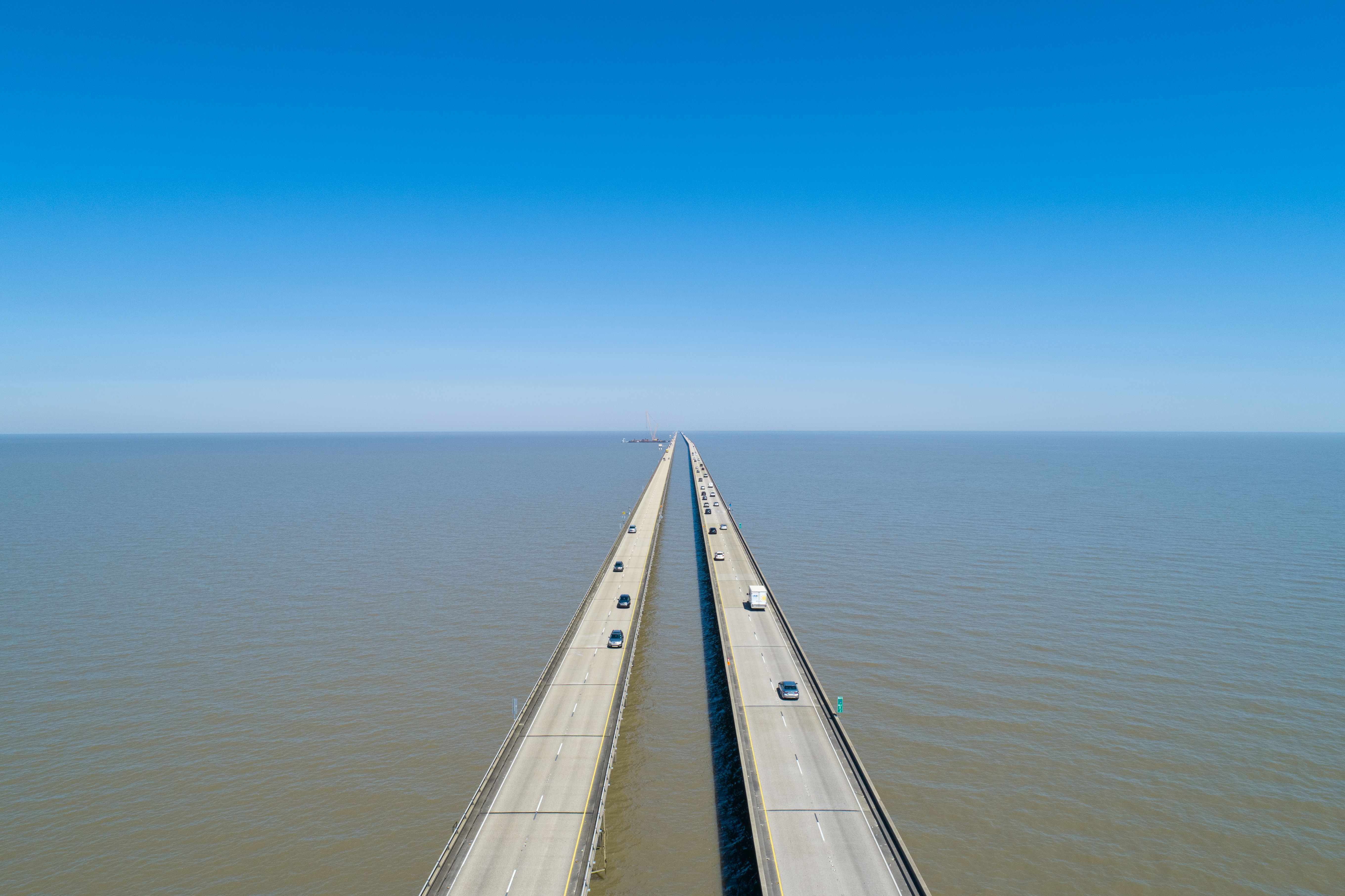 Lake Pontchartrain Causeway bridge with some cars passing on it from an above angle