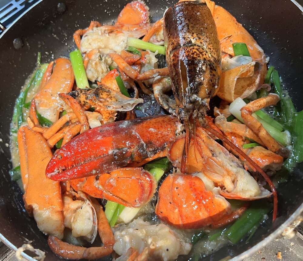 Asian style lobster with scallions and ginger