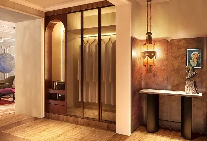 Hallway with built-in glass closet, console table, sculpture, framed art, and decorative hanging lamp.