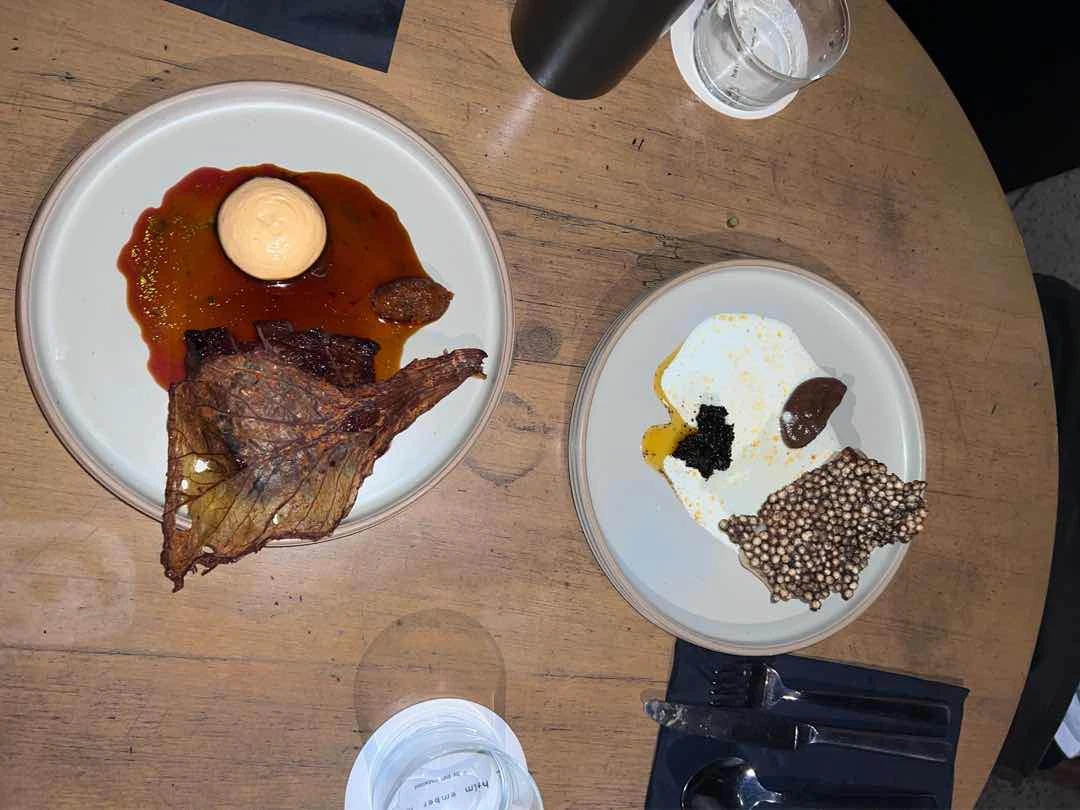 left: steak bavette; right: sea bass, cauliflower, xo of The Test Kitchen by Josh Boutwood