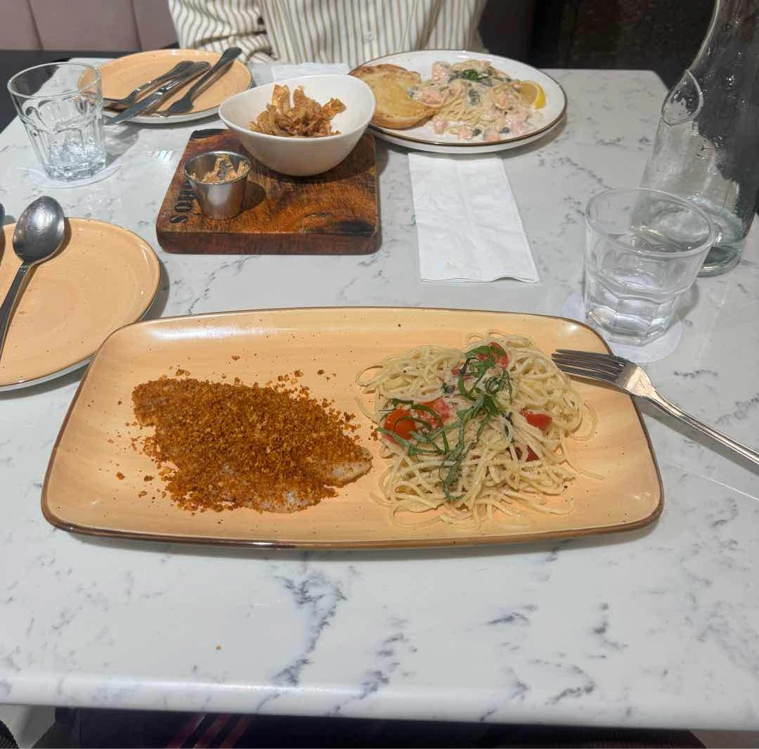 Parmesan crusted fish with tomato basil pasta, onion skins