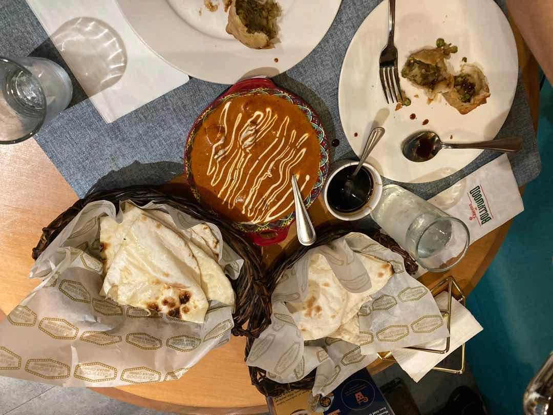 Buttered Chicken and Garlic Naan. And some Sambousa with Tamarind Sauce.  of Bollywood - Greenbelt