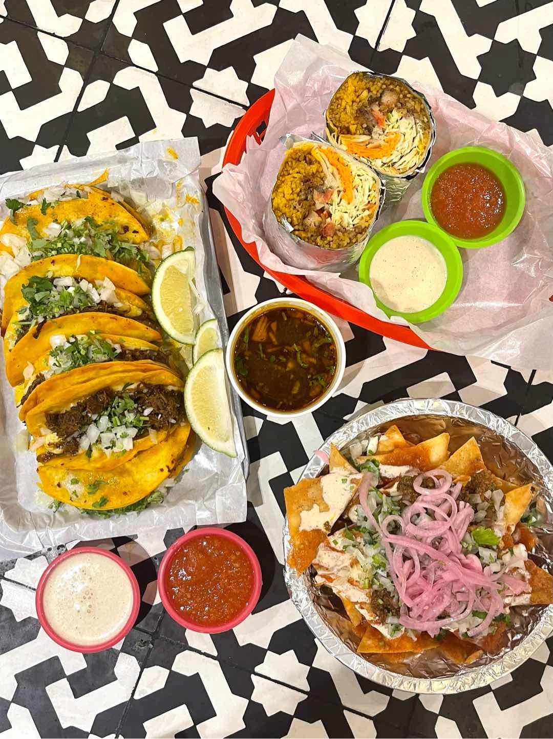Pork carnitas burrito, tortilla chips, quesabirria tacos of El Poco Cantina