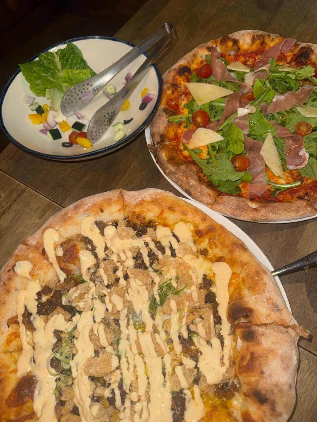 sisig pizza and prosciutto pizza