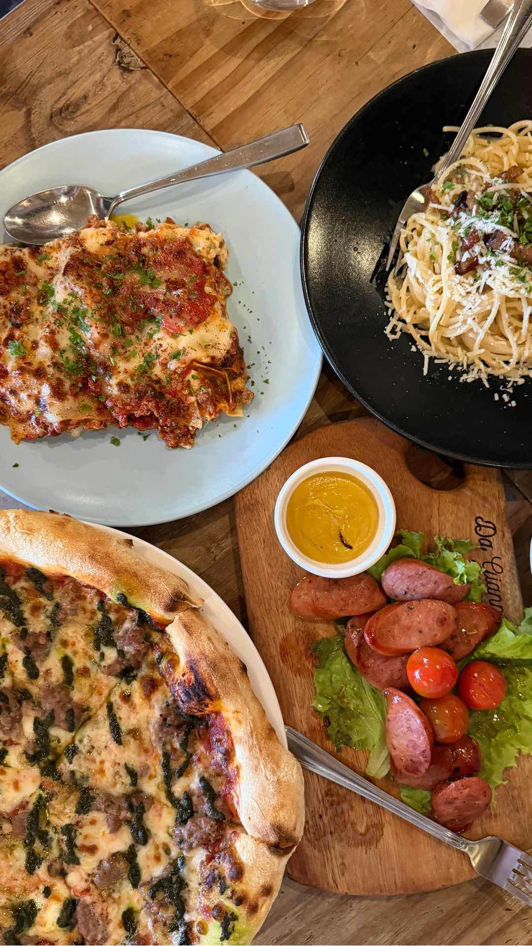 lasagna, carbonara, beef pesto, and sausage platter