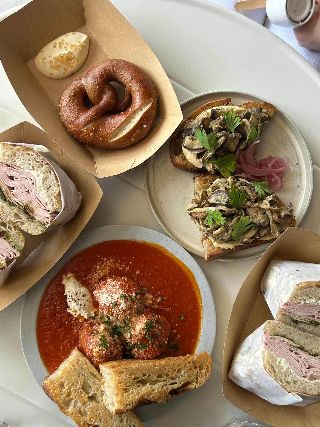 mortadella sandwich, meatballs in tomato sauce, hummus toast, pretzel of Scratch