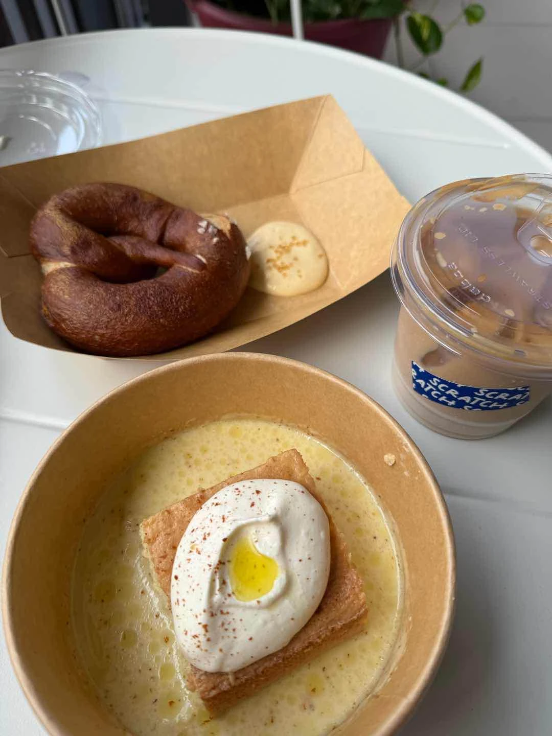 Soft pretzel, olive oil tres leches and iced flat white
