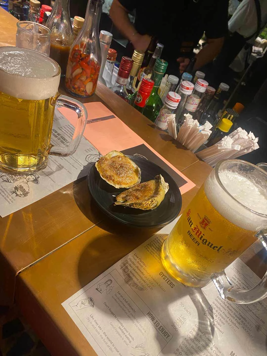 Baked oyster with beer on tap