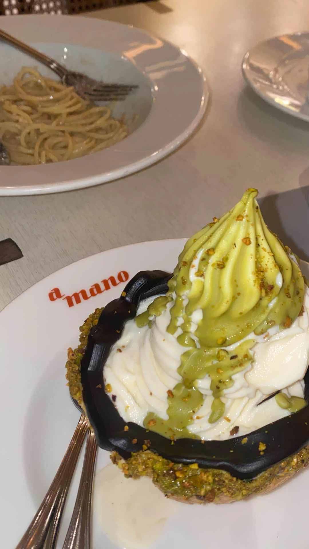 Pistachios & Chocolate Fudge Burrata Soft Serve of a mano