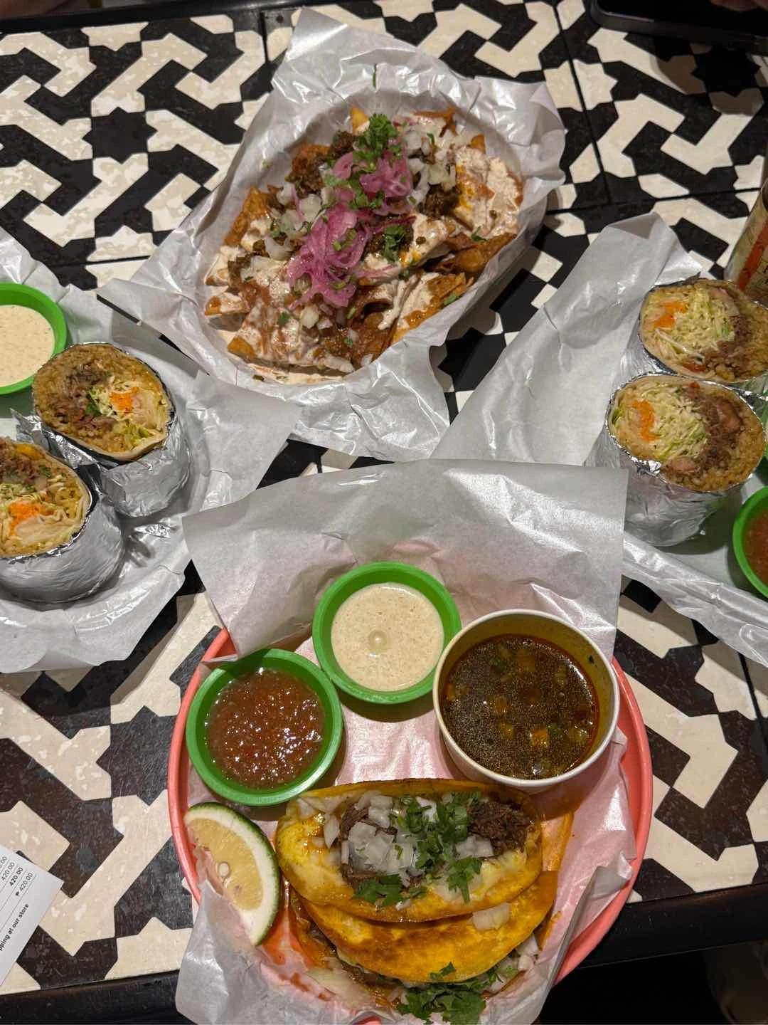 Beef barbacoa burritos, tortilla chips, quesabirria tacos of El Poco Cantina