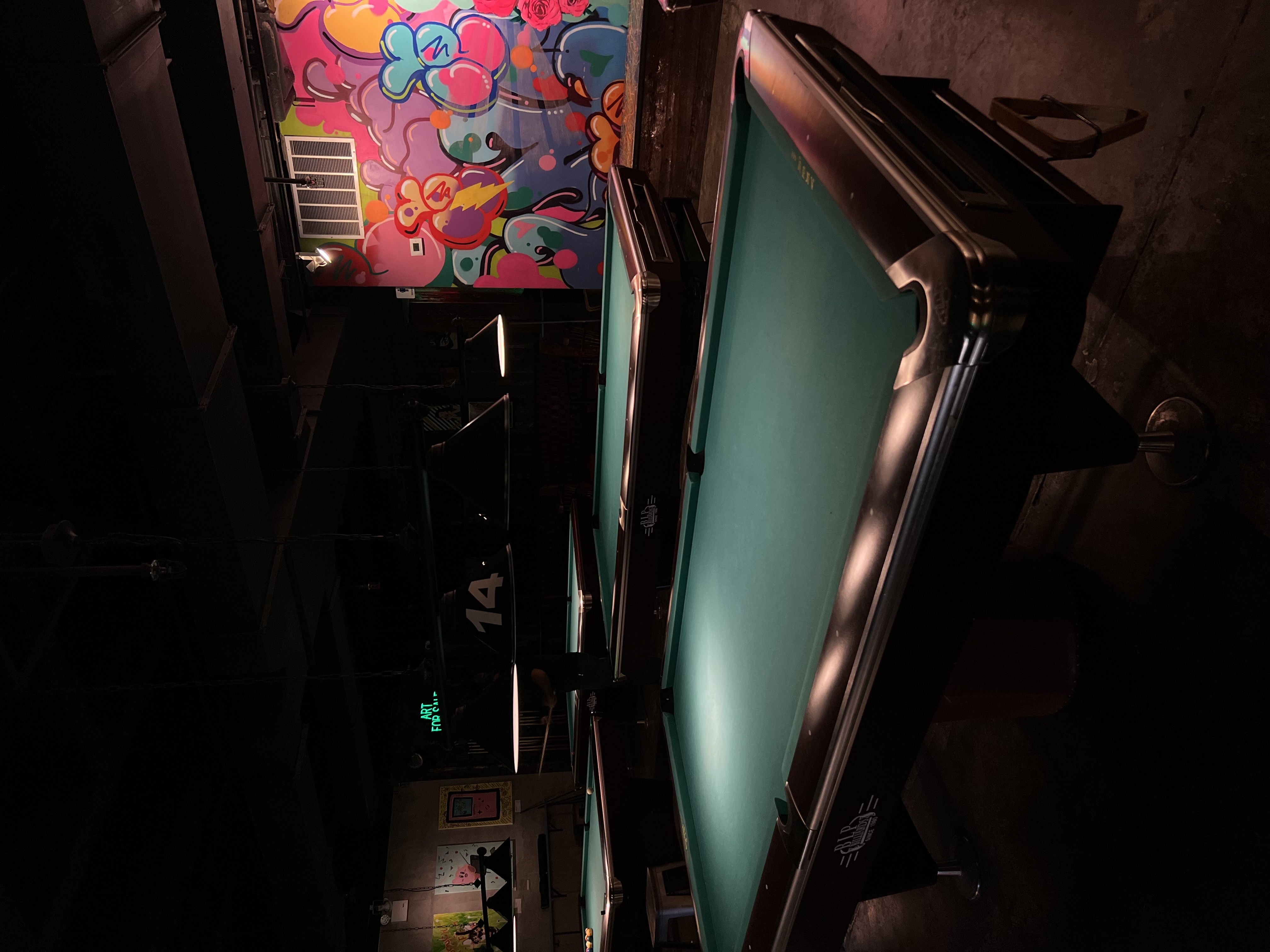 Game hall interior with pool tables and local art at Sour Mouse on Delancey Street, Lower East Side