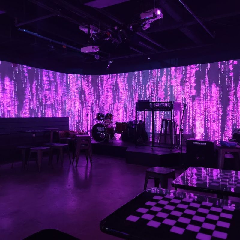 Immersive projection-covered interior at Sugar Mouse, a game hall and music venue in the East Village