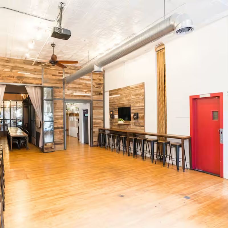 Sunlit loft interior with rustic wood furnishings at The Farm Soho on Broadway