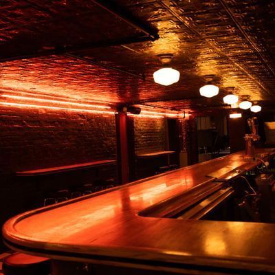 Classic dive bar interior with checkered floor and exposed brick at PubKey in Greenwich Village