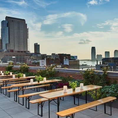 Illuminated rooftop bar with downtown skyline views at ART SoHo on the 11th floor of Arlo SoHo