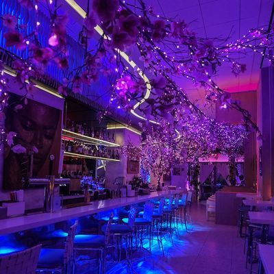Cherry blossom installations and dining tables at Skinos restaurant in the Financial District