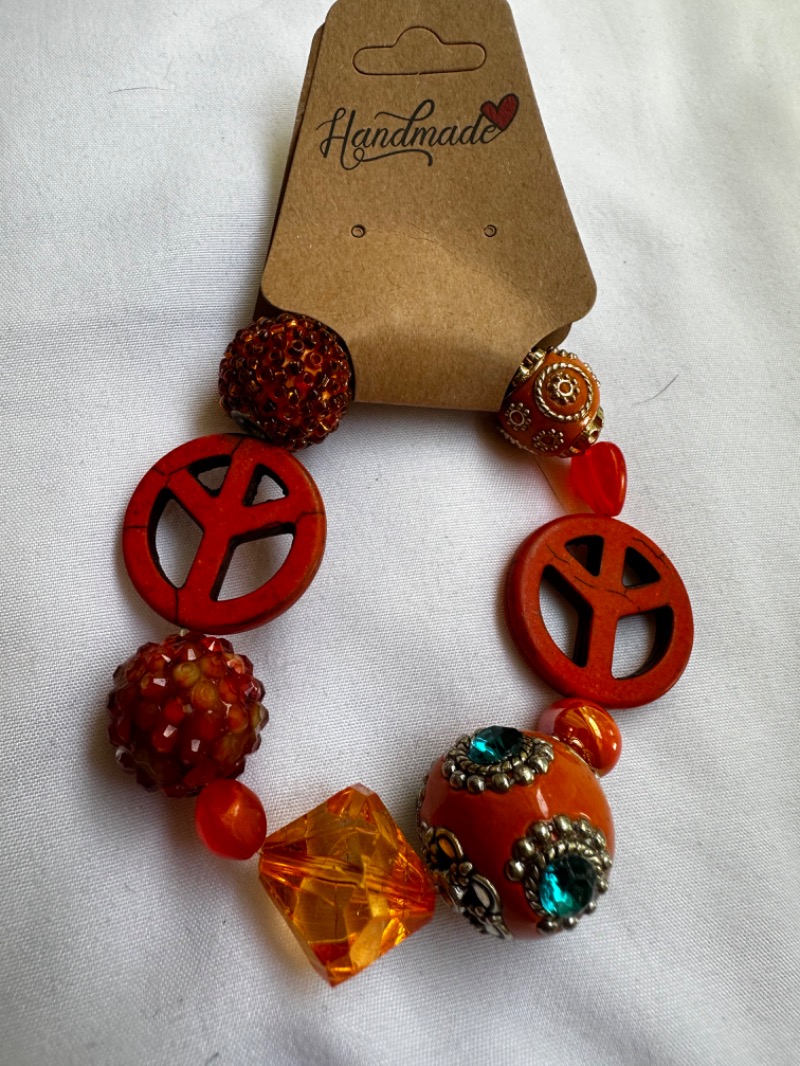 Handmade Bracelet with Orange and Red Beads, Gem Details, and Peace Sign Design