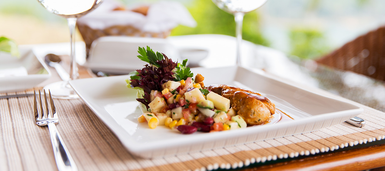 Plate of food with a fork and a glass of wine