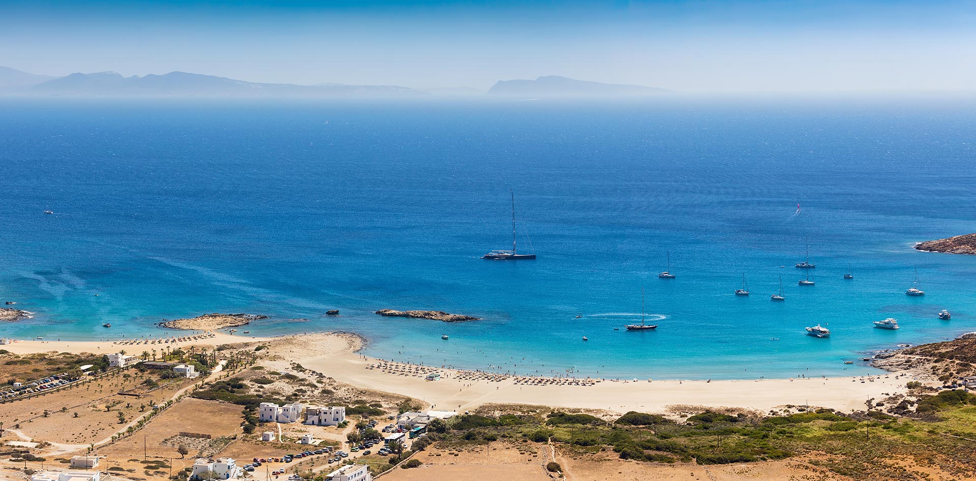 Aerial view of a beach with mountains in the background