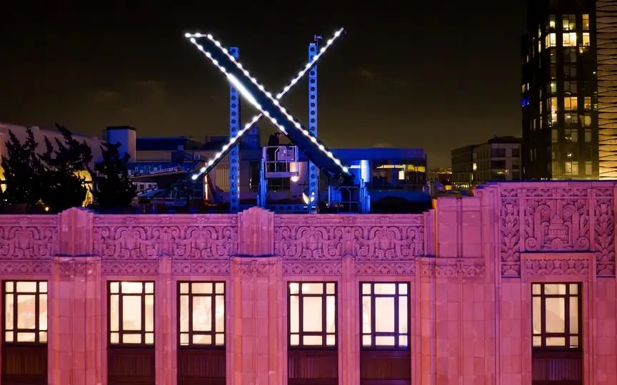 Workers install lighting on an "X" sign atop the company headquarters, formerly known as Twitter, in downtown San Francisco, Friday, July 28, 2023. (AP)