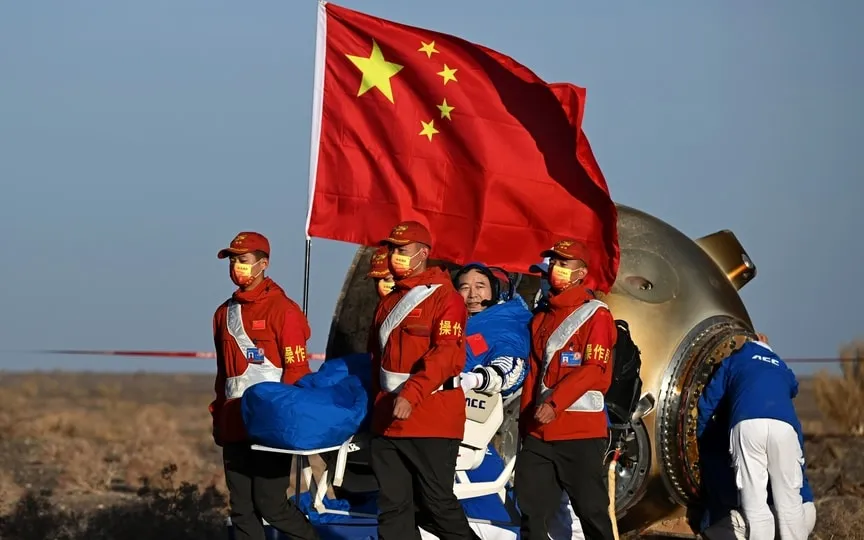 In this photo released by Xinhua News Agency, astronaut Jing Haipeng waves as he is carried out of the re-entry capsule of the Shenzhou-14 manned space mission after it landed successfully at the Dongfeng landing site in northern China's Inner Mongolia Autonomous Region, Tuesday, Oct. 31, 2023. (AP)