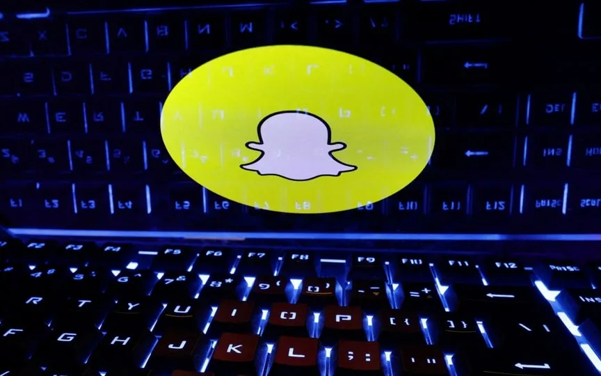 A keyboard is placed in front of a displayed Snapchat logo in this illustration taken February 21, 2023. (REUTERS)