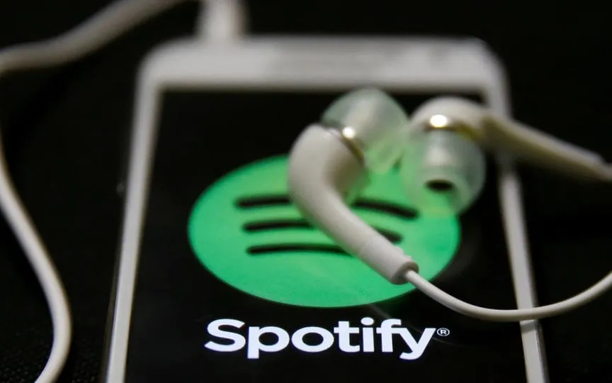 Earphones are seen on top of a smart phone with a Spotify logo on it, in Zenica. (REUTERS)