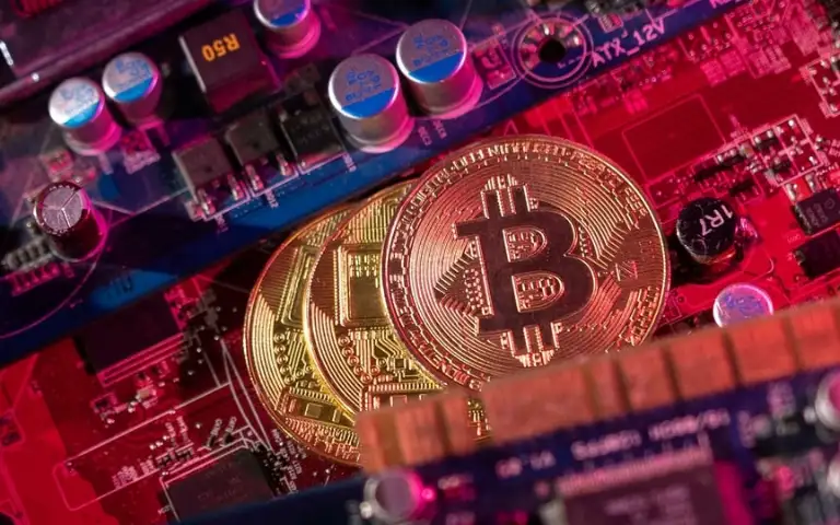 Representations of cryptocurrency Bitcoin are placed on a PC motherboard in this illustration taken June 16, 2023. (REUTERS)