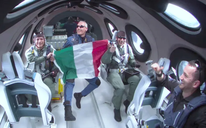 Italian Air Force officers unfurled their nation's flag and peered out windows at the curve of Earth while enjoying a few minutes of weightlessness