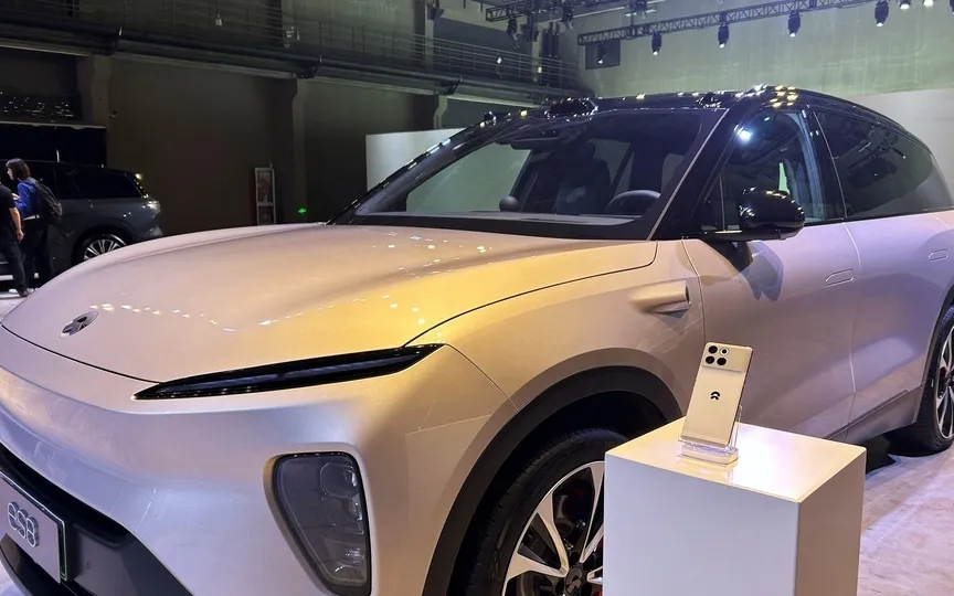 A Nio Phone is displayed next to a Nio ES8 SUV during the Chinese electric vehicle (EV) maker's tech day in Shanghai, China September 21, 2023. (REUTERS)