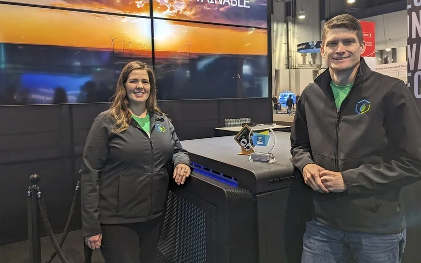 Genesis Systems co-founders Shannon Stuckenberg (L) and David Stuckenberg pose with a WaterCube device that extracts water from the air during the Consumer Electronics Show (CES) in Las Vegas, Nevada, on January 12, 2024. (AFP)