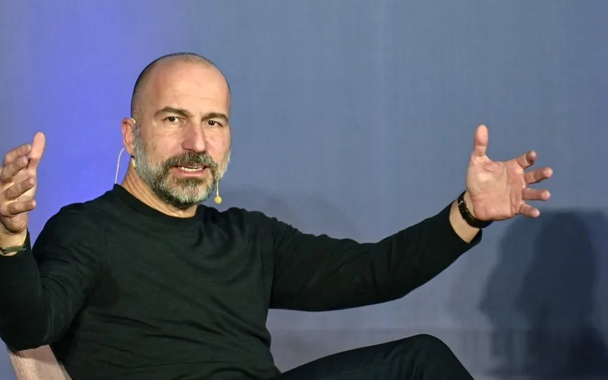 Uber CEO Dara Khosrowshahi gestures while speaking to Nandan Nilekani, Chairman and Co-Founder of Infosys, during a conversation on building population scale technology, (AFP)